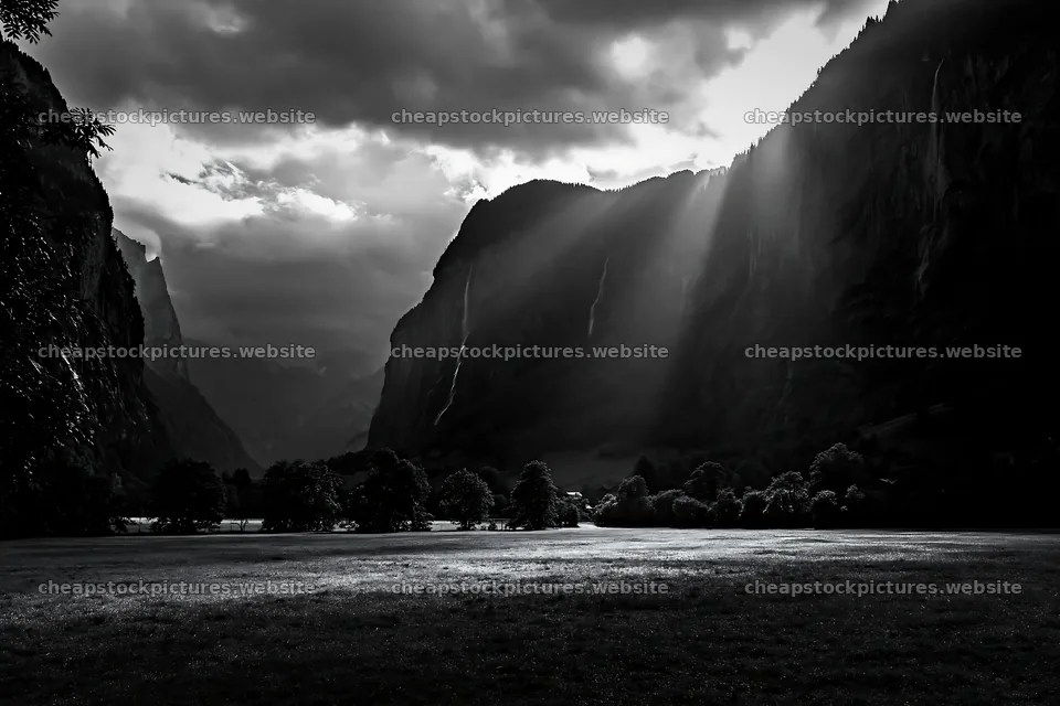 Lauterbrunnen Valley meadow light rays create dramatic scenery – stock pictures 9722x6480