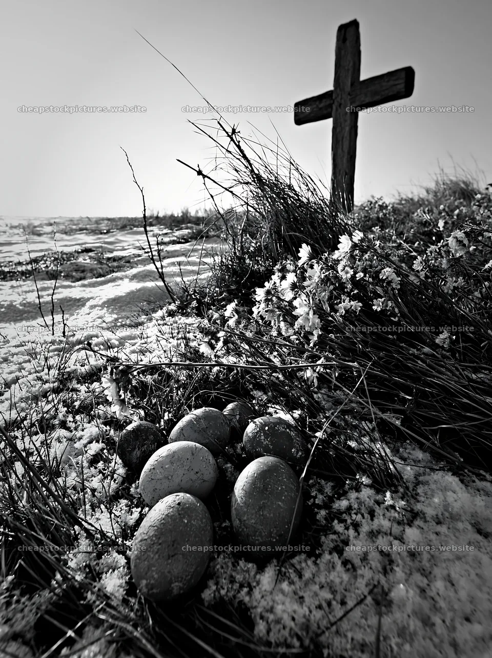 Weathered Christian cross in snowy meadow with eggs nearby – stock pictures 6866x9174