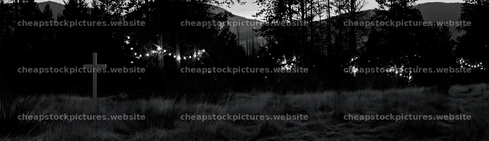 White Christian cross in a remote meadow at dusk – stock pictures 14762x4268