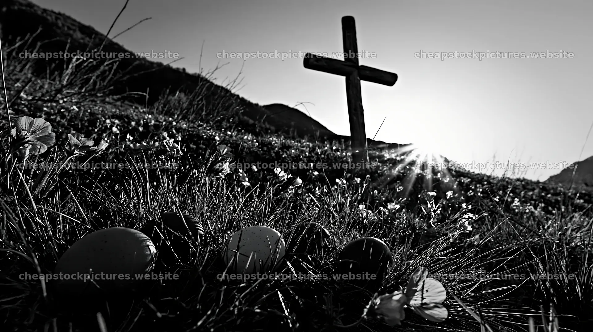 Christian cross in summer meadow with backlight and flowers – stock pictures 10608x5938