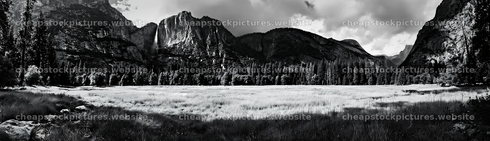 Waterfall in alpine meadow with mountains in background – stock pictures 14762x4268