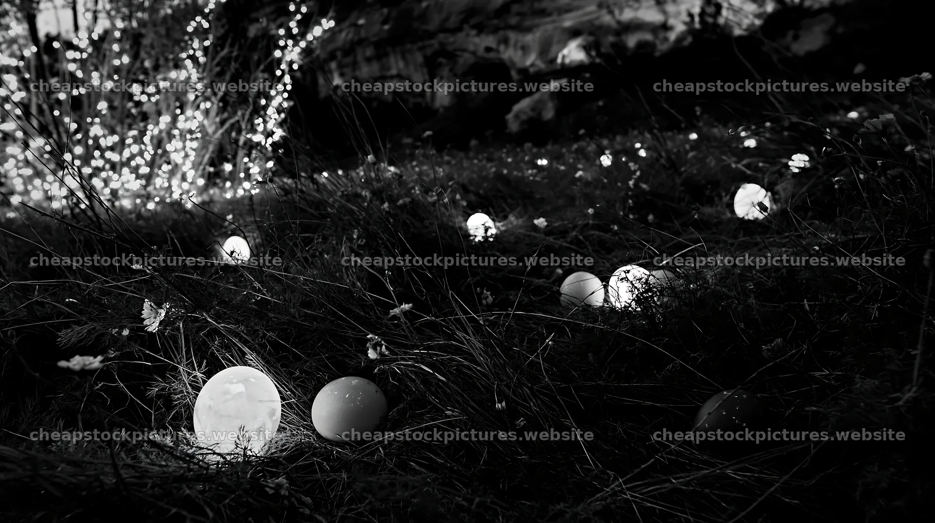 Christmas lanterns at dusk in meadow by cave – stock pictures 10608x5938
