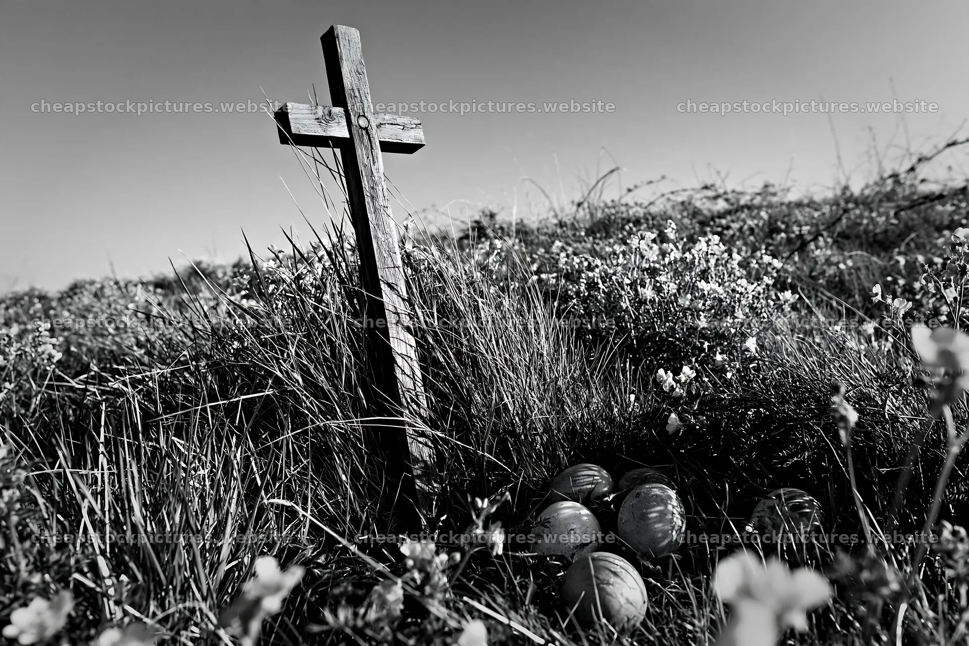 Christian cross in yellow wildflower meadow with stones – stock pictures 9722x6480