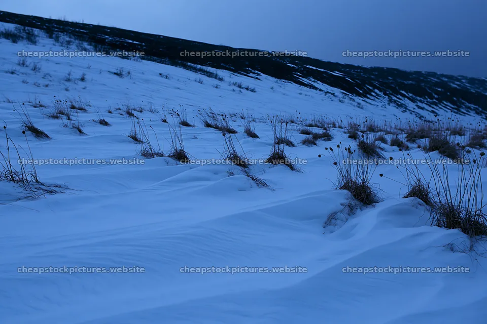 Snowy highland meadow with grass and hills in the distance – stock pictures 9722x6480