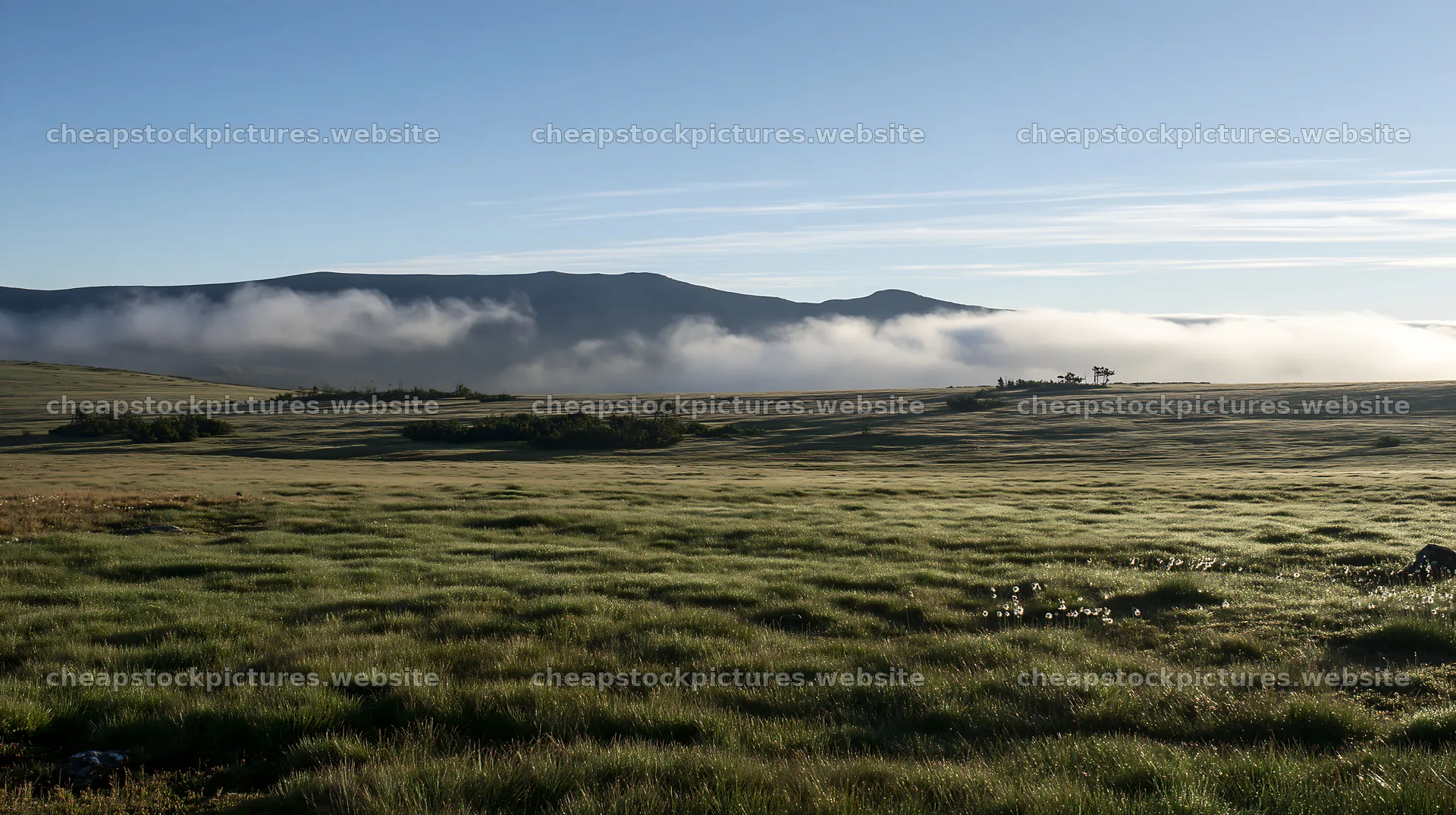 Dewy meadow with fog over hills at sunrise – stock pictures 10608x5938