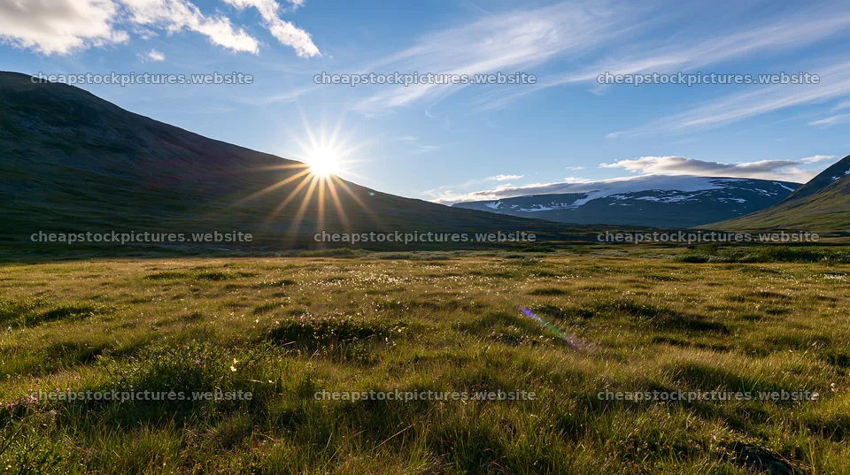 Sunbeams shining over Jotunheimen valley meadow – stock pictures 10608x5938