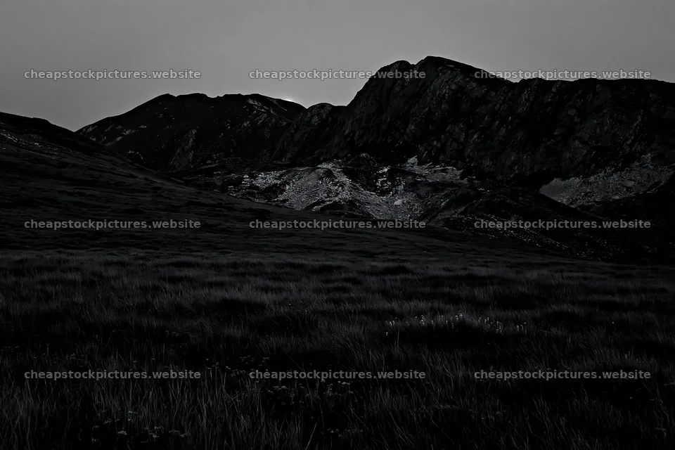 Moonrise over a meadow near mountains at dusk – stock pictures 9722x6480