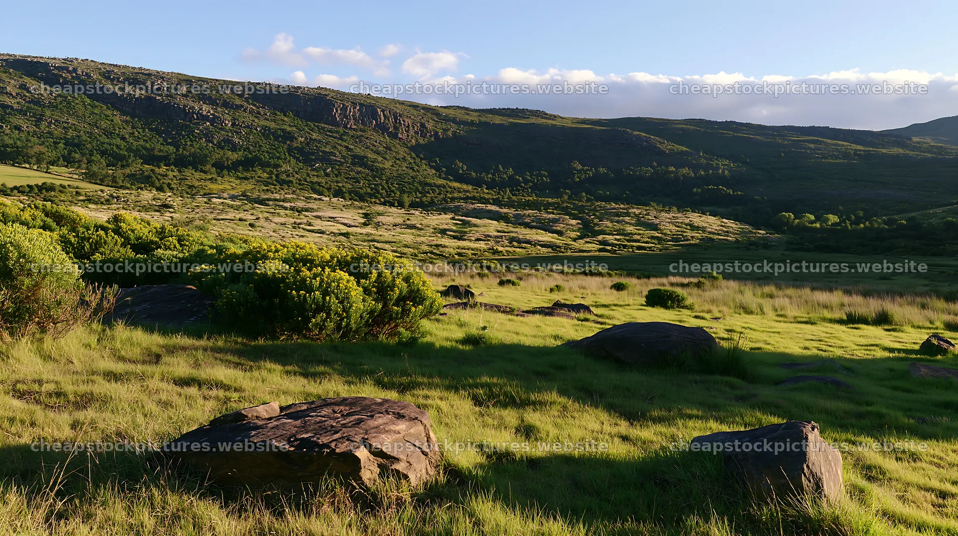 Vast meadow landscape with rocks and distant hills – stock pictures 10608x5938